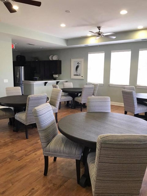 A dining room with a round table and chairs.