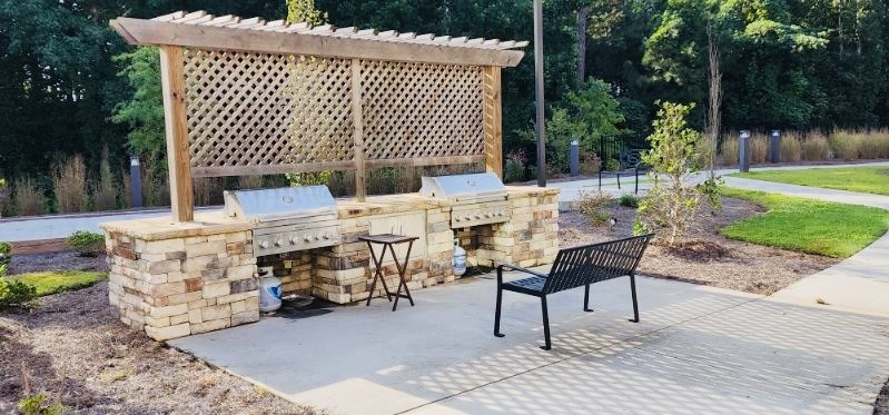 A wooden pergola with a bench underneath it.