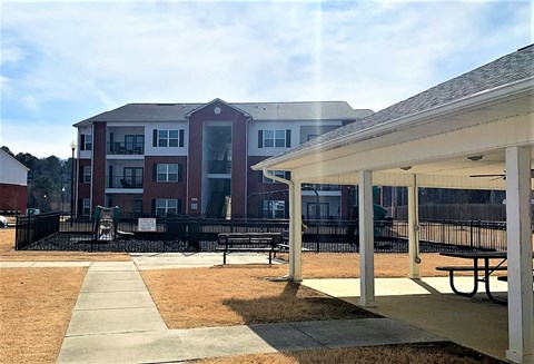 a building with a picnic area and benches in front of it