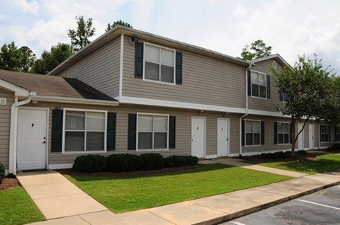 A two-story house with a gray exterior and white trim.