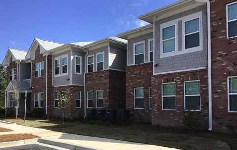 A row of houses with brick and siding exteriors.