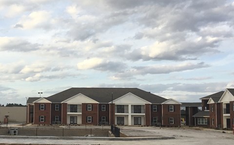 a building is being constructed in front of a cloudy sky