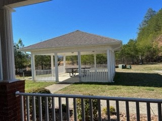 a gazebo with a picnic table in a yard
