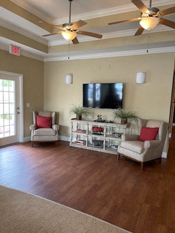 a living room with furniture and a tv on the wall