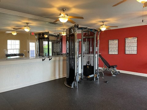 a room with a gym and a ceiling fan