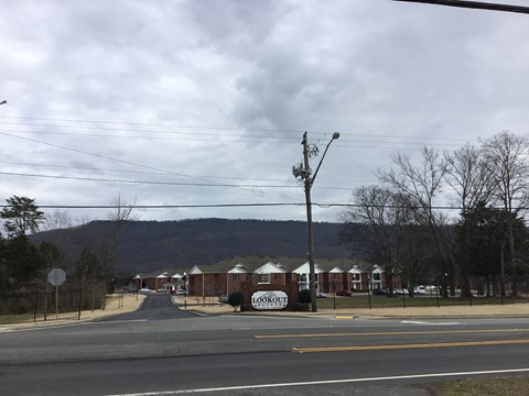 A street view with a sign that reads "Lockout" in front of a building.