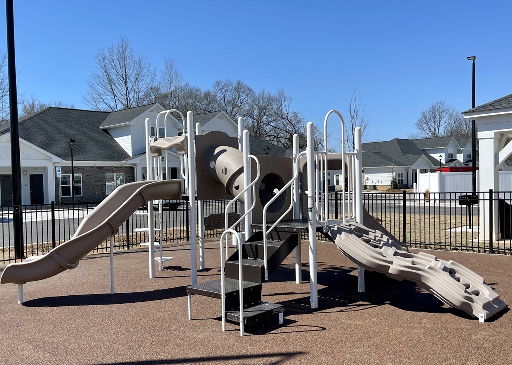 a playground with a slide and climbing equipment in a park