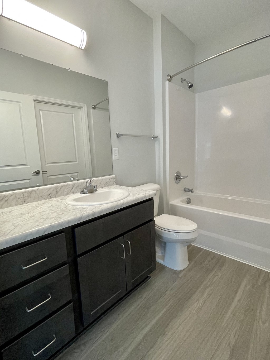 an empty bathroom with a sink toilet and shower