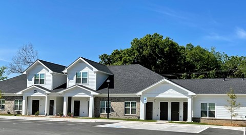 A two-story house with a white exterior and a black roof.