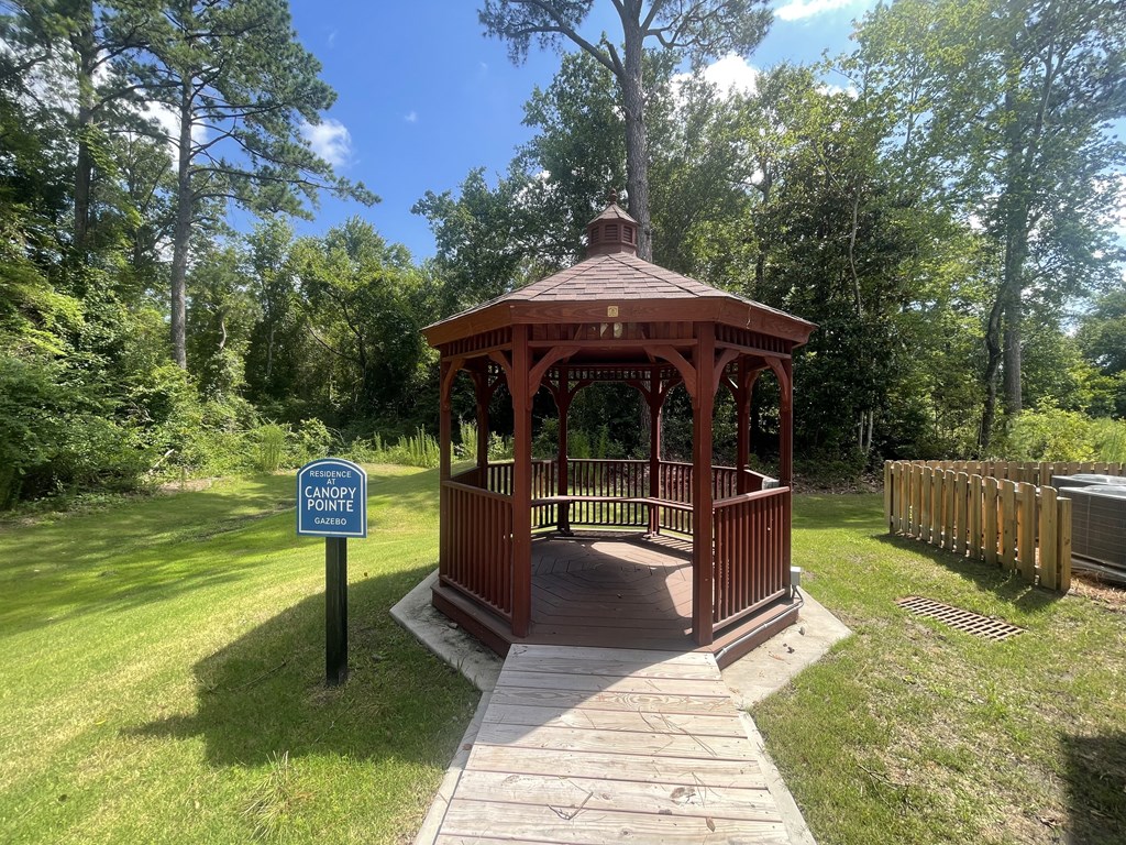 A gazebo is located in a grassy area with a sign that says "Canoe Point.".