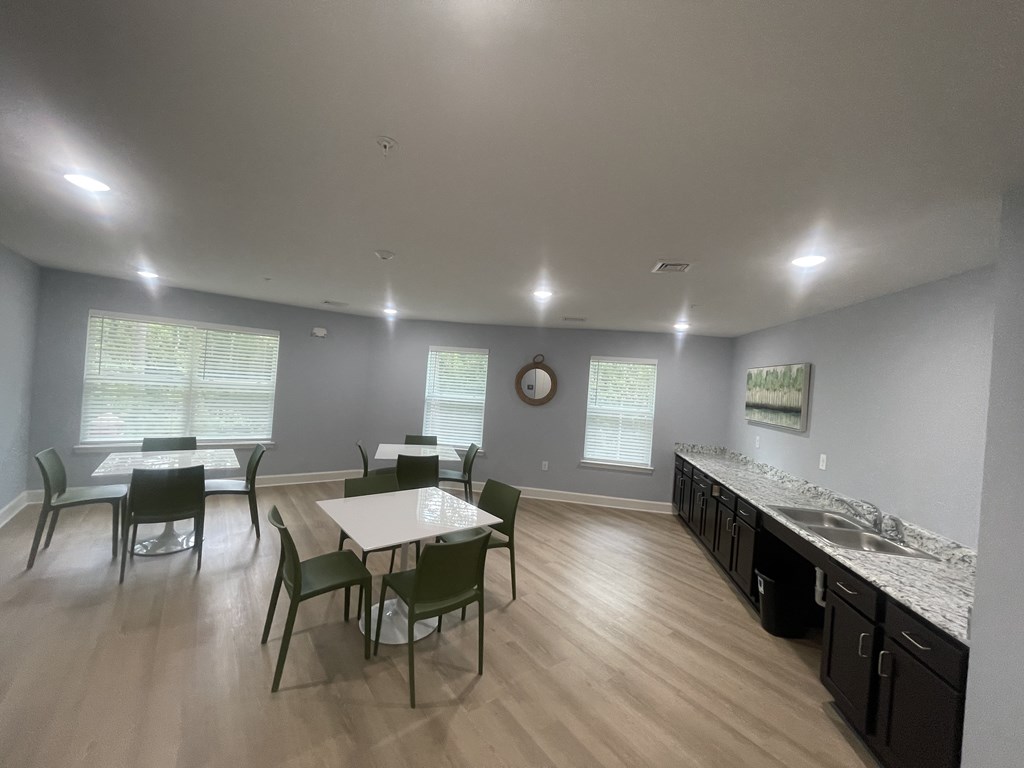 A dining room with a table and chairs.