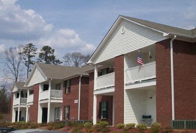 an apartment building with an flag on the balcony