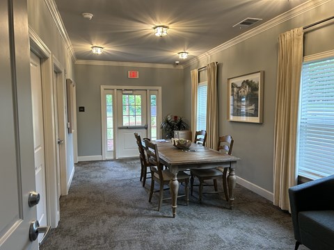 A dining room with a table set for six.