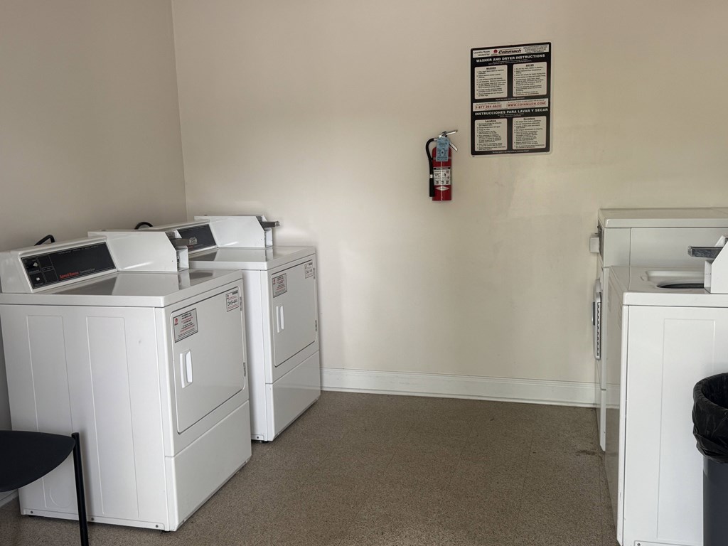 A room with a fire extinguisher and a sign on the wall.