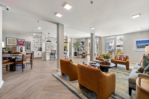 A living room with a couch, chairs, and a coffee table.
