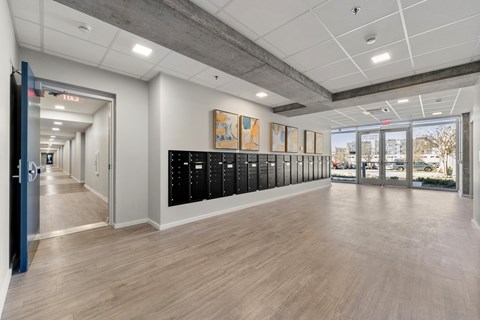 A hallway with a row of lockers on the right side.