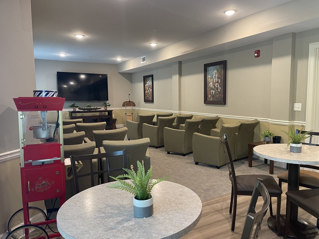 A room with a white table and chairs.