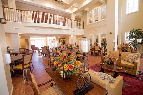 A large, well-decorated living room with a balcony.