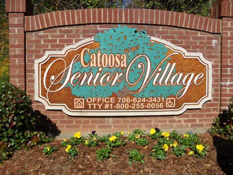 the sign for the office is shown on a brick wall