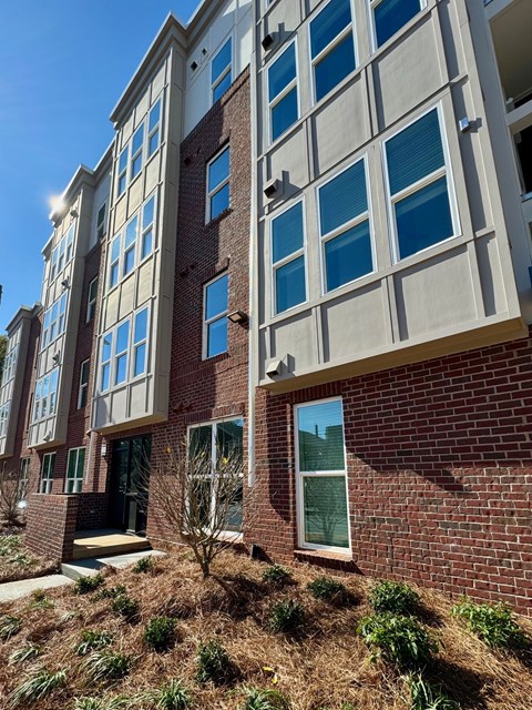 A multi-story building with a brick facade and large windows.