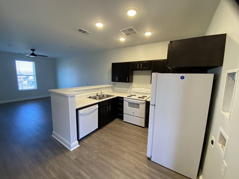 A kitchen with white appliances and a white refrigerator.