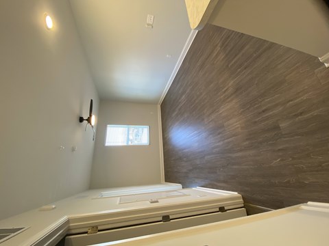 A bedroom with a bed and a window.