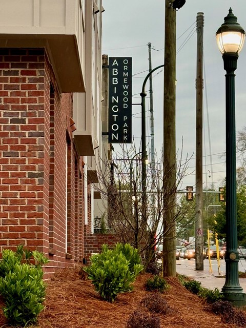 A brick building with a sign that says Abbington Park.