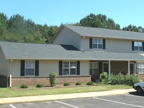 a house with a car parked in a parking lot