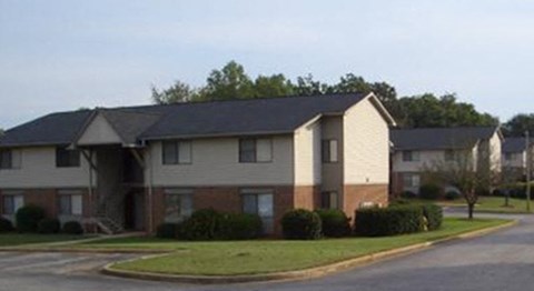 an apartment building on a street in a neighborhood