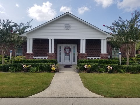 a house with a white door and a sidewalk in front of it
