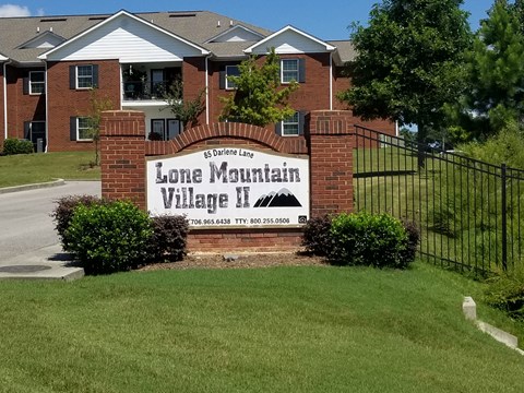 a large sign in front of a brick building