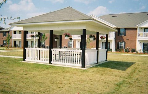 A white porch with a black roof and pillars.