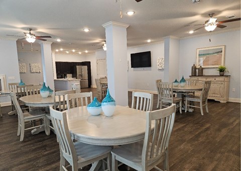 A dining room with a white table and chairs.
