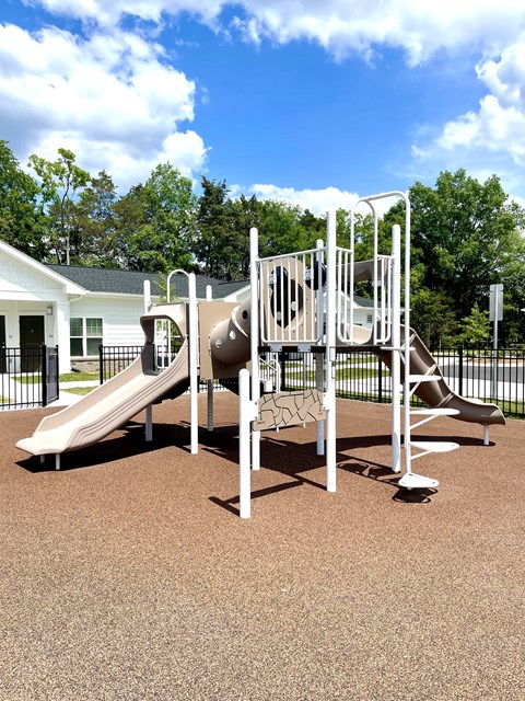 A playground with a slide and a climbing frame.