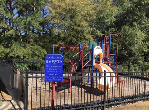 a playground with a slide at a park