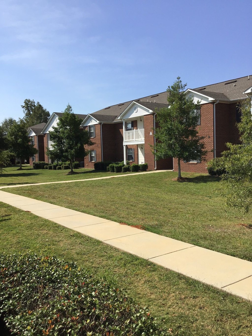 a sidewalk in front of an apartment building