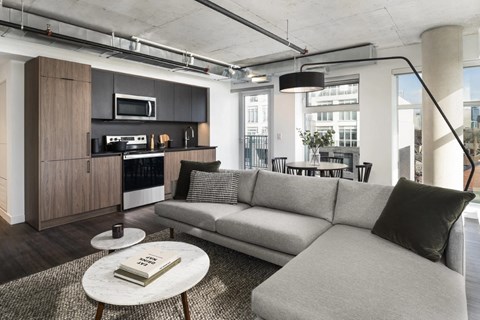 A modern living room with a grey sofa and a coffee table.