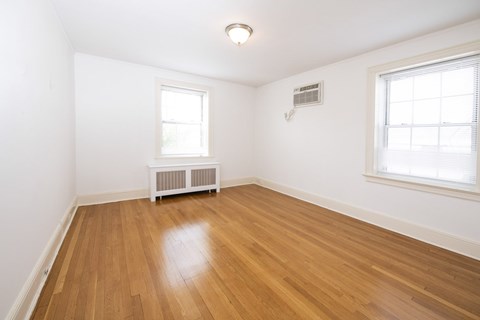 A room with wooden floors and a window.