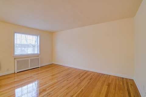 Empty room with wooden floor and window.