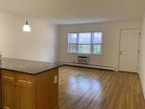 A kitchen with wooden cabinets and a granite countertop.