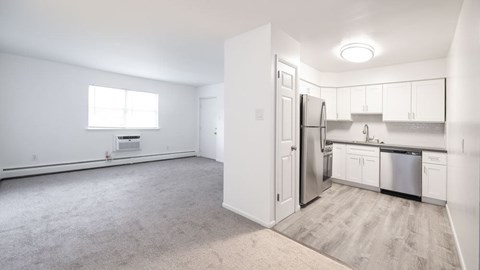 A kitchen with white cabinets and stainless steel appliances is shown.