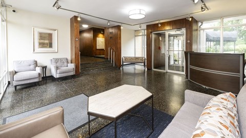A spacious living room with a variety of seating options and a coffee table.