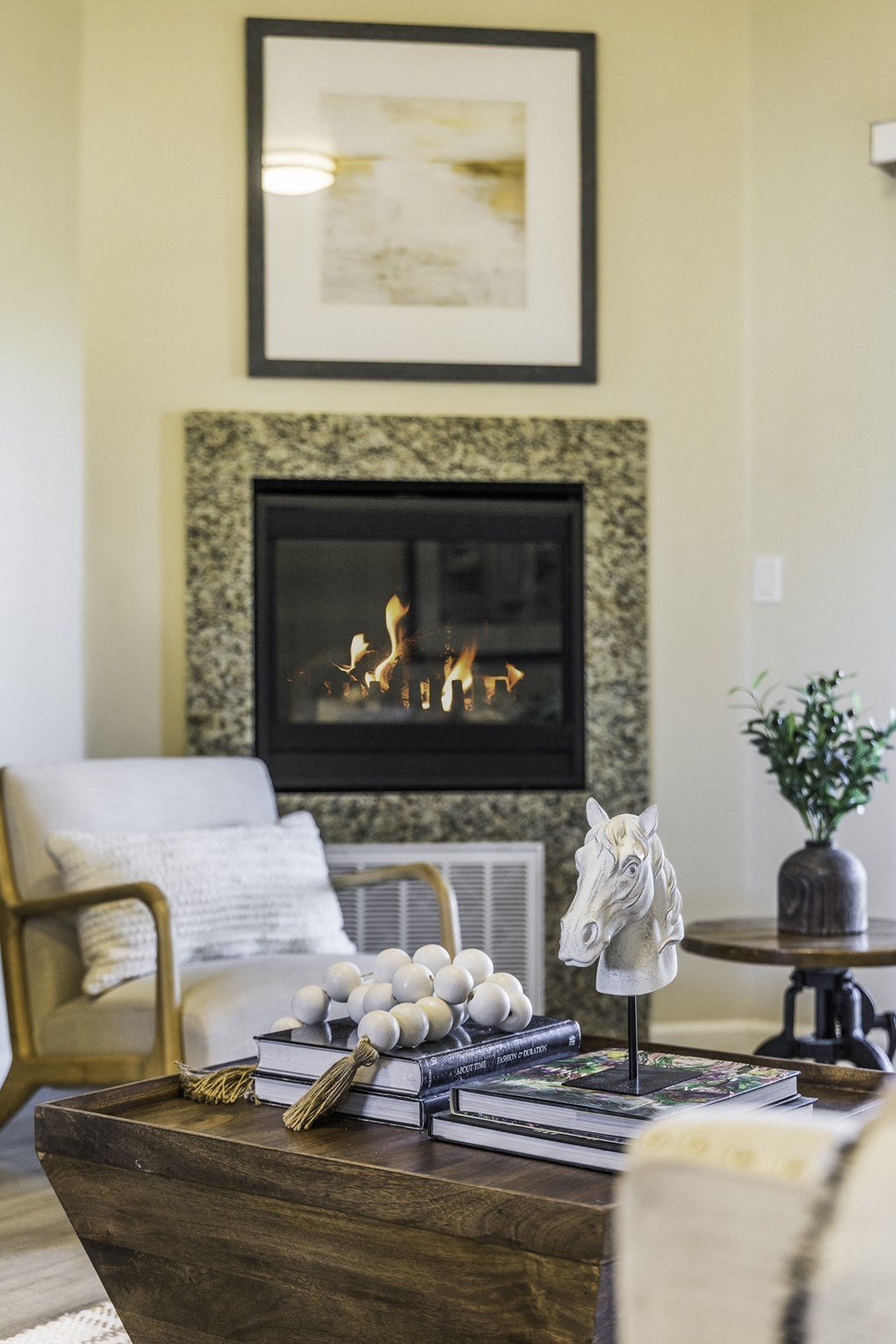 A living room with a fireplace and a chair.