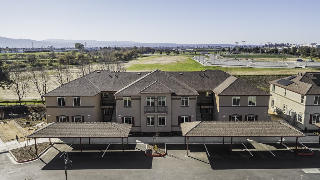 A large building with a parking lot in front.
