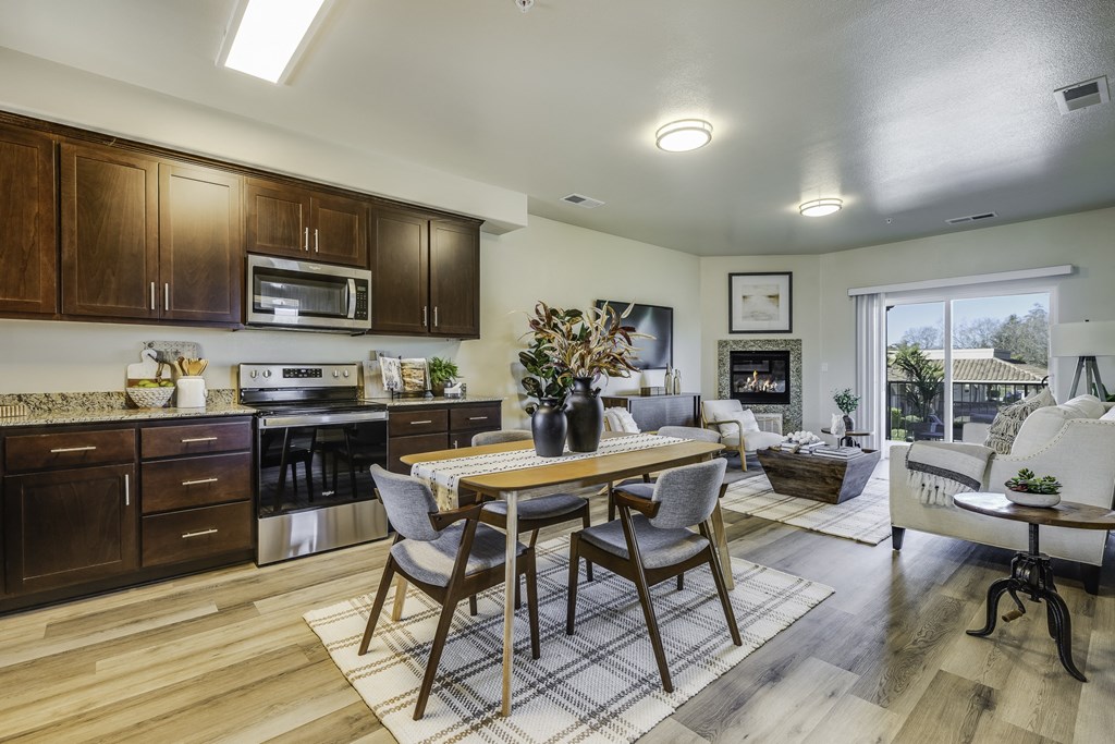 A modern kitchen with a dining table and chairs.