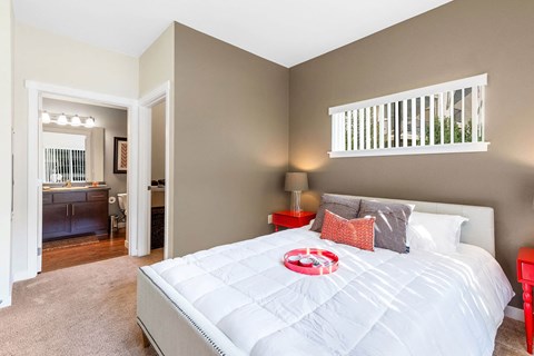 Bedroom with white bedding and modern decor at Mullan Reserve Apartments, Missoula, MT 59808