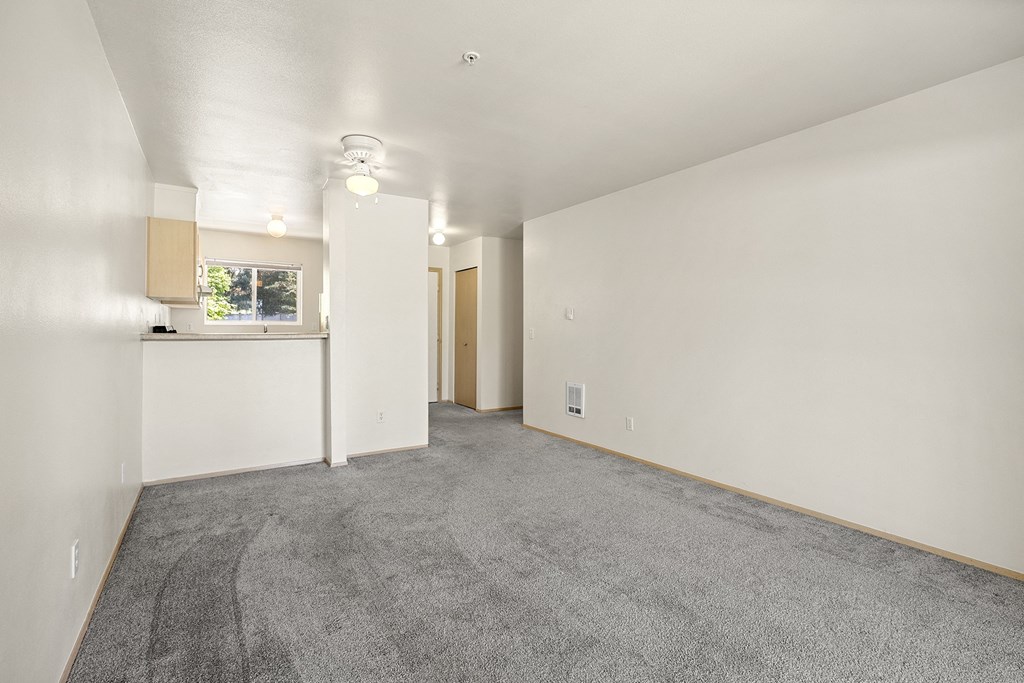 a living room with white walls and gray carpet at Mill Pond Apartments, Auburn, 98092