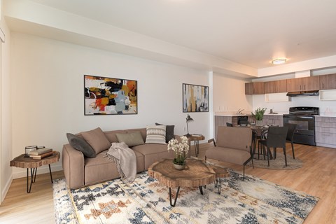 a living room with two couches and a coffee table in front of a kitchen with a at Jefferson Yards, Tacoma, WA 98402