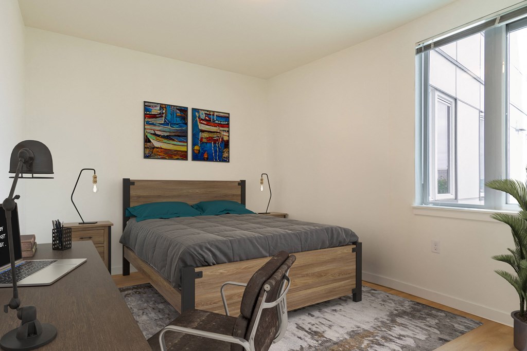 a bedroom with a bed and desk in a 555 waverly unit at Jefferson Yards, Tacoma, WA