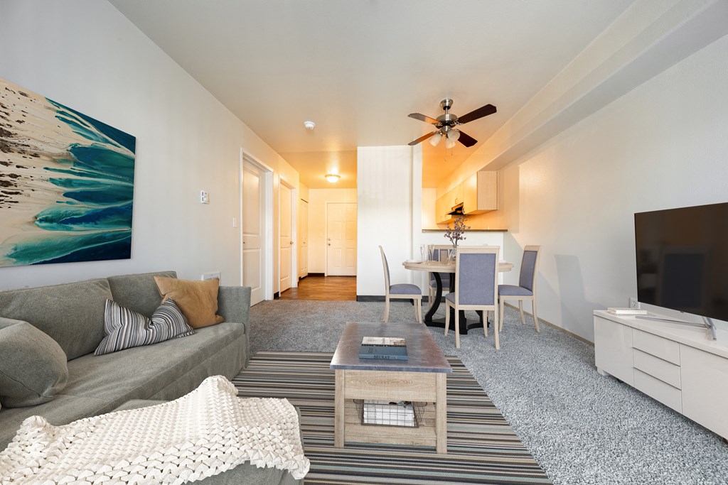 a living room with a couch a coffee table and a tv at Mill Pond Apartments, Auburn, WA 98092